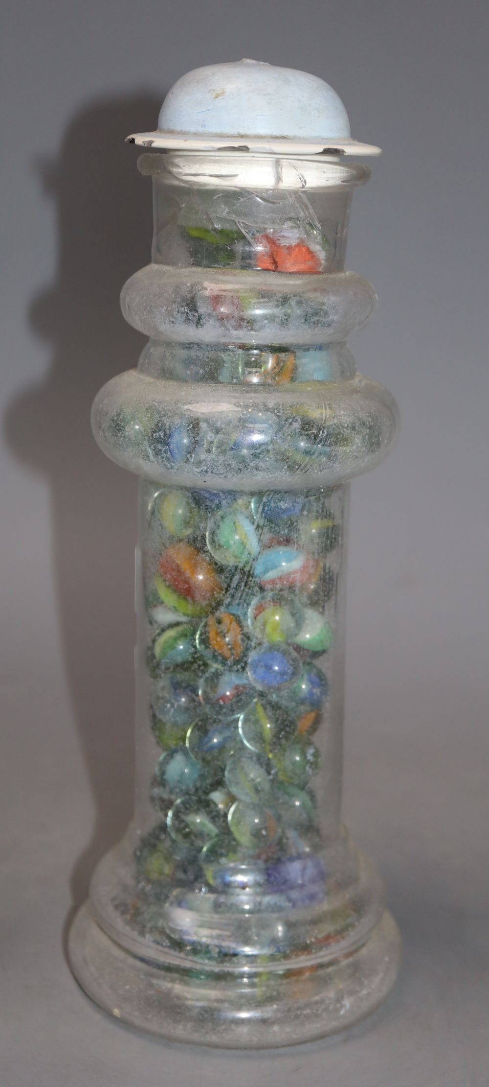 A Victorian glass vase, containing a collection of Victorian and later coloured marbles, height 27cm